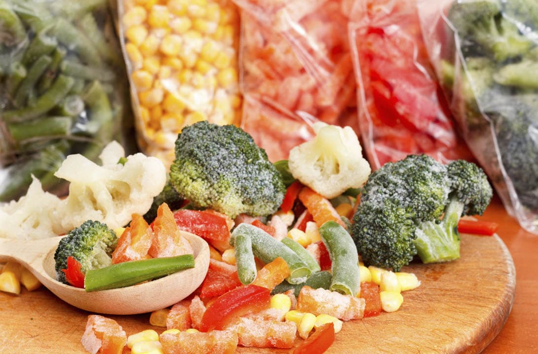 Assorted frozen vegetables on a cutting board